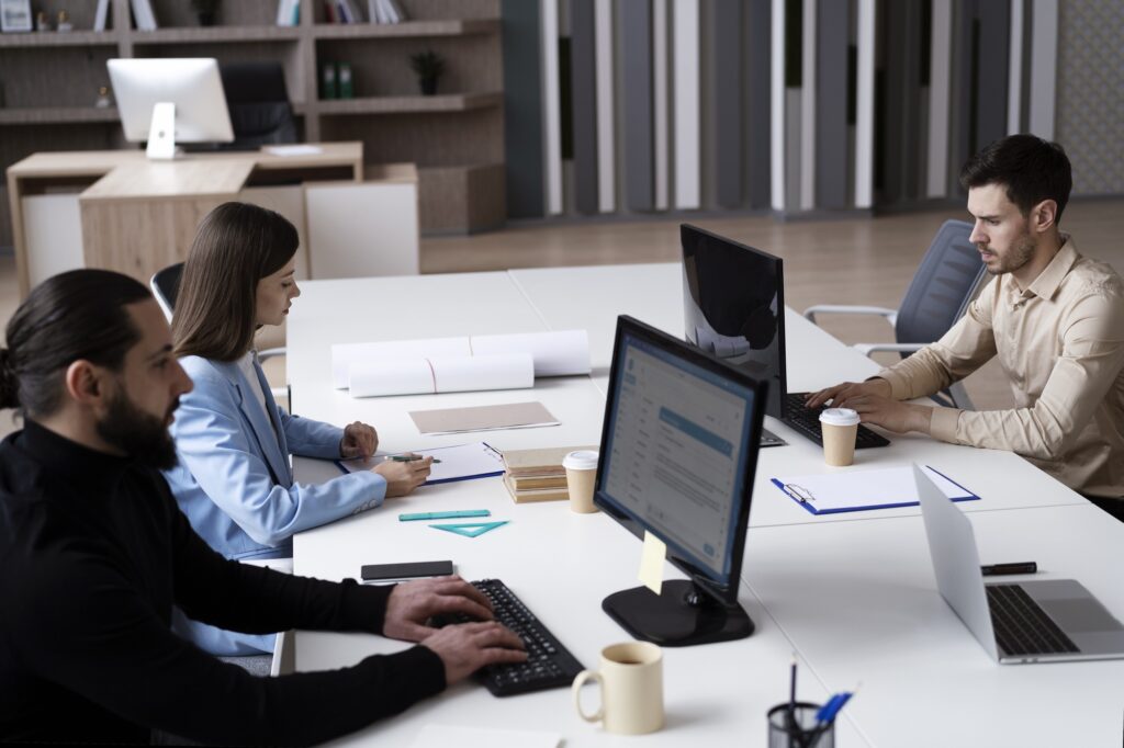 Team working in a modern office, showcasing the importance of maintaining reliable office technology.